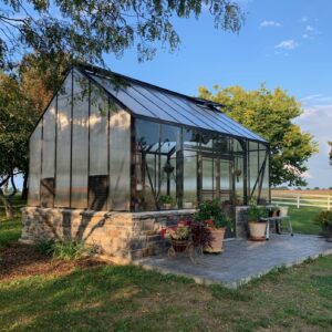 Cottage Greenhouse by Cross Country with double sidewall doors and masonry pony wall