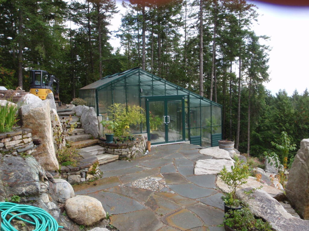 Walipini partially underground greenhouse off of hill slope