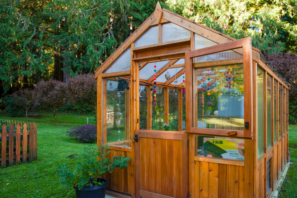 Charley's Alpine Insulated Heritage Wood Cedar Greenhouse with double pane glass, pony walls, and Dutch Door